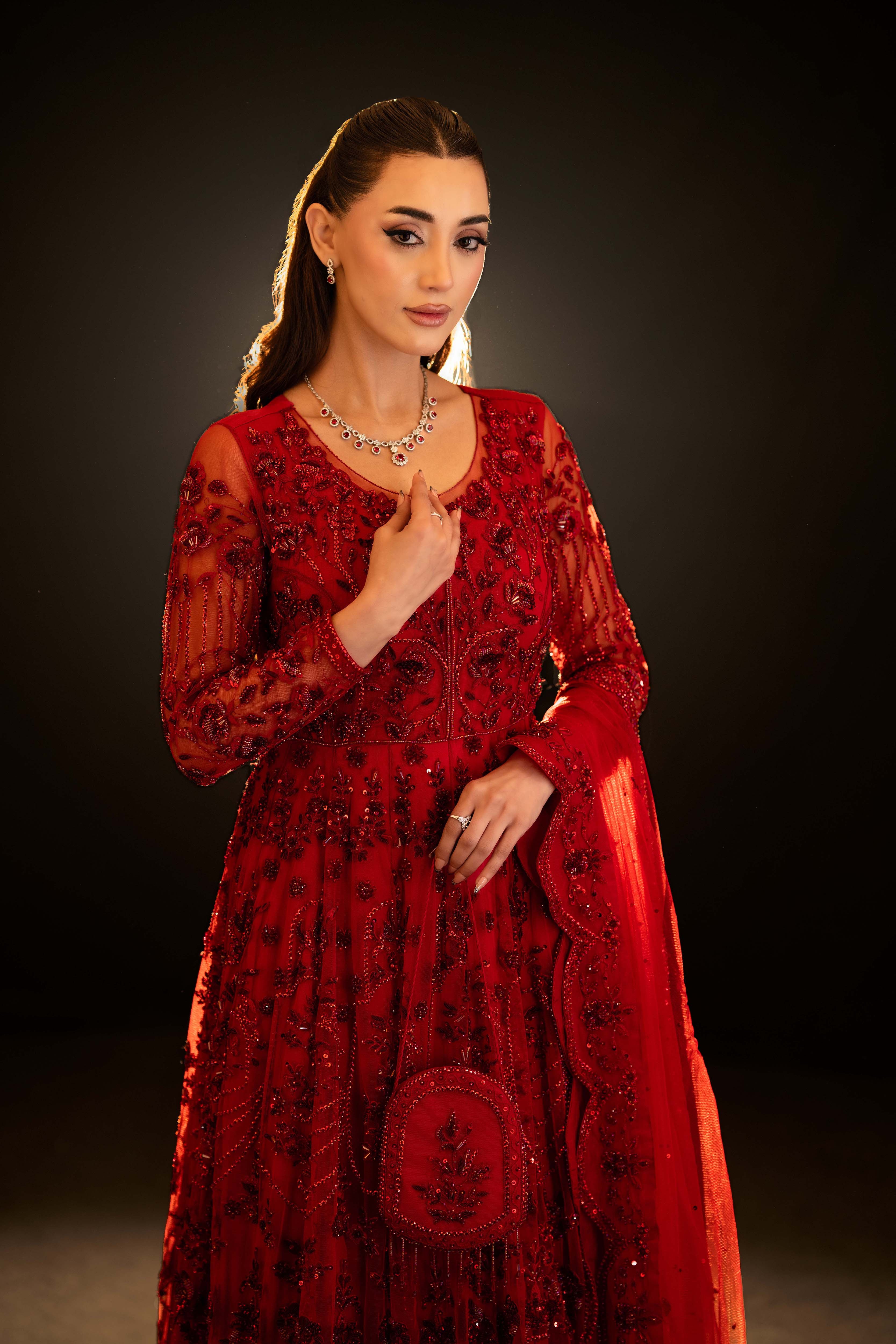 Mid-length view of red embroidered bridal gown with sequins, long sleeves and embellished dupatta