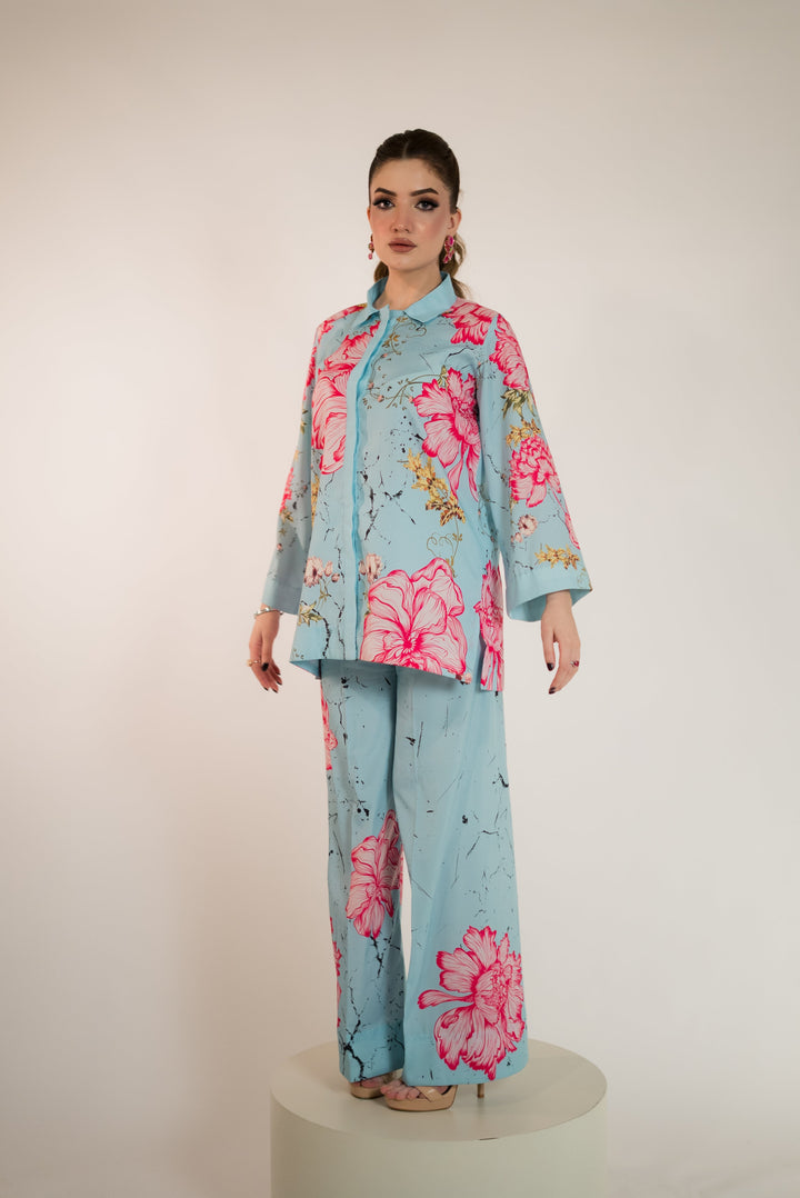 Full-length front view of a blue pret wear co-ord in luxury printed crepe silk, straight-cut shirt with pink floral print and matching straight pants, from our boutique in Islamabad F-7.